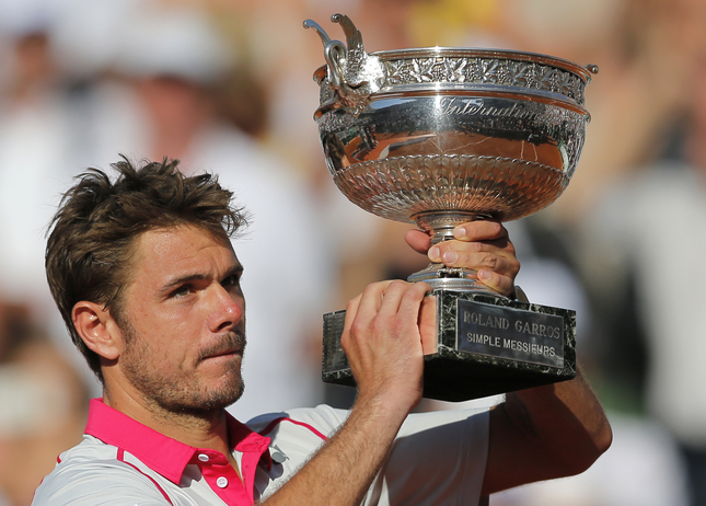 Switzerland's Stan Wawrinka lifts the cup after defeating Serbia's Novak Djokovic in their final match of the French Open tennis tournament at the Roland Garros stadium, Sunday, June 7, 2015 in Paris. Wawrinka won 4-6, 6-4, 6-3, 6-4. (AP Photo/Christophe Ena)